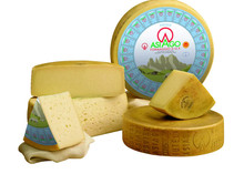 A Formaggio Asiago DOP Cheese 168开奖官方开奖结果查询 幸运8官网开奖官方结果 直播历史记录查询 wheel, with half and quarter slices displaying its yellow interior